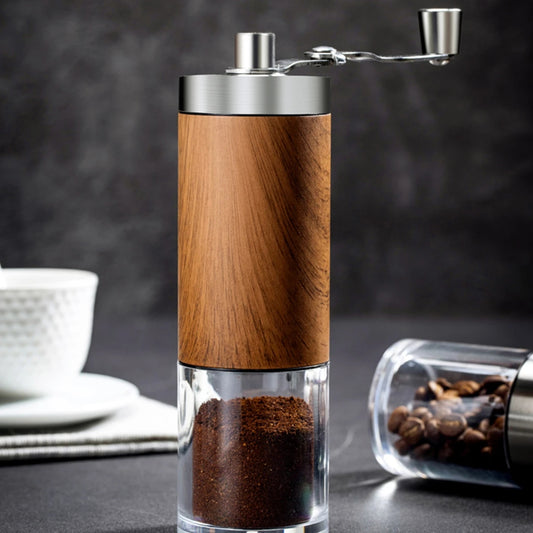 Wood-grain hand coffee grinder with stainless crank and a clear catch jar of fresh grounds