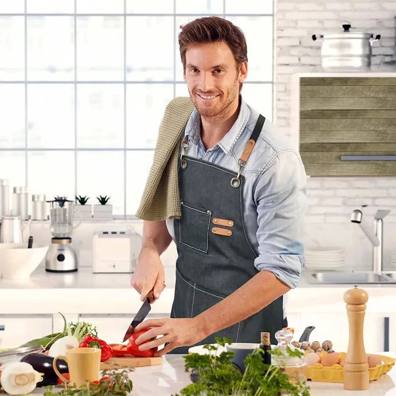 Waxed Canvas Barista Apron displayed at an angle, showing the durable canvas material and functional pocket design for campfire use.
