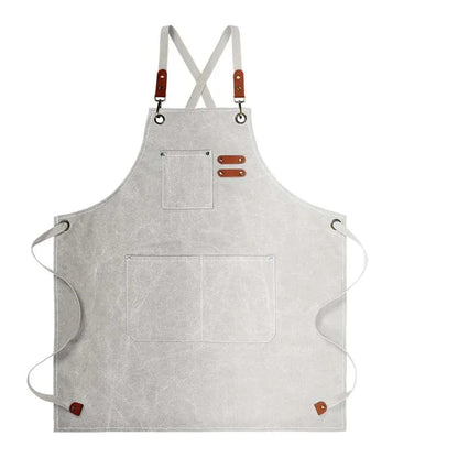 Waxed Canvas Barista Apron laid flat showing full front panel with leather straps and utility pockets