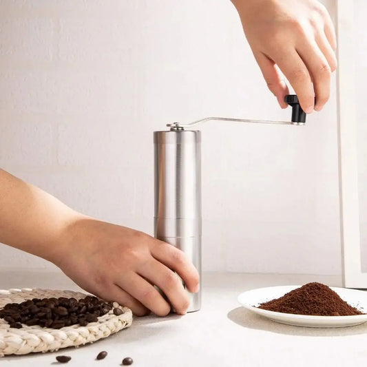Trailside Ceramic Burr Hand Coffee Grinder displayed front-facing with ceramic burr mechanism visible through transparent housing